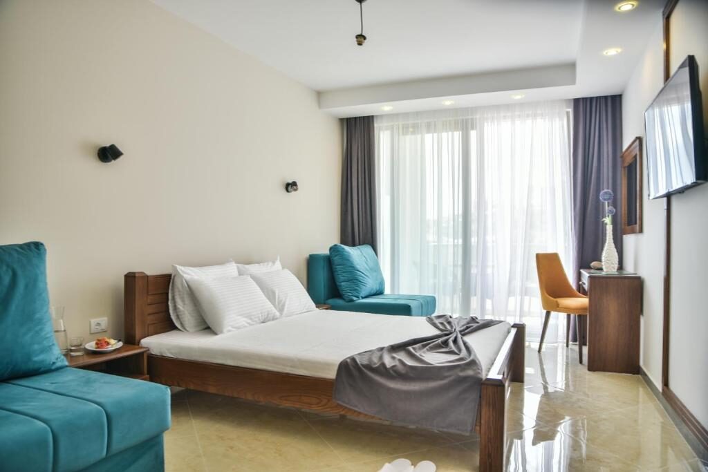 Spacious room with seating, balcony doors and a flat-screen TV